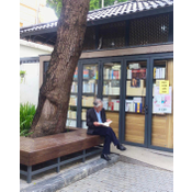 My father reading a book outside a bookstore in Hanoi in 2017.